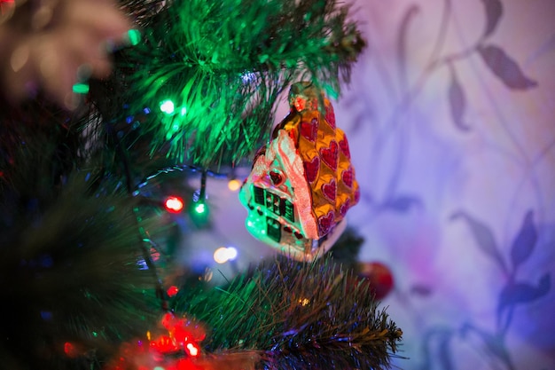 Beautiful toys on the christmas tree with garland