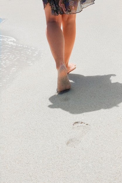 Beautiful traces with feet near the sea on nature background