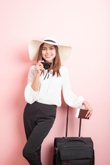 Beautiful traveler woman is exciting in pink  