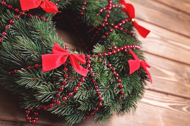 Beautiful trendy Christmas wreath on wooden surface