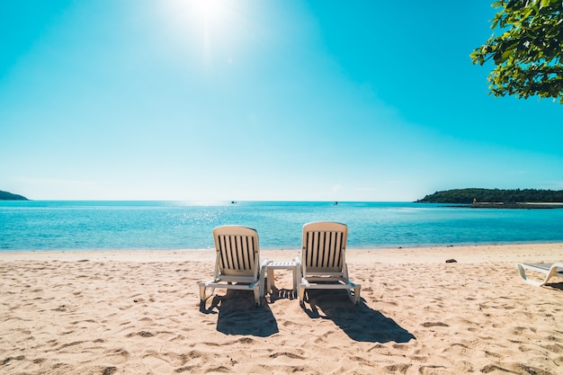 Beautiful tropical beach and sea with chair on blue sky