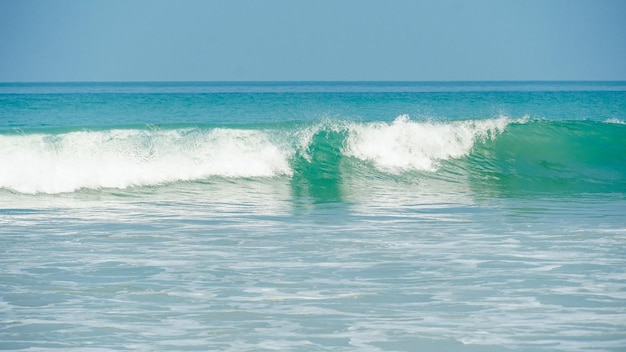 Beautiful tropical beach with blue sky abstract texture background close up soft wave lapped