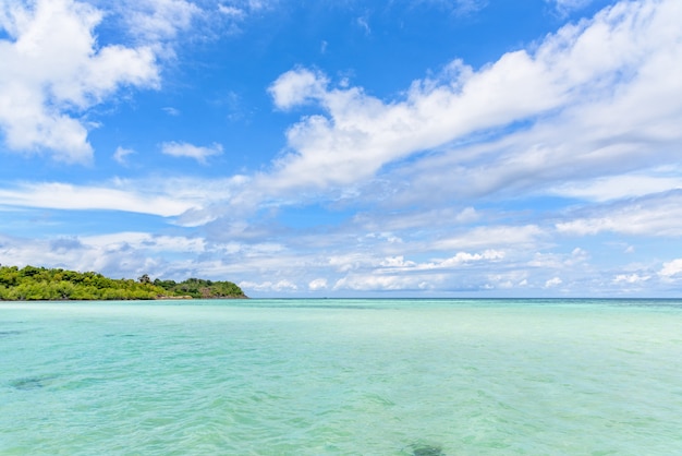 Beautiful tropical nature landscape of clear sea near the beach, green island, white cloud and blue sky in summer at Ko Ra Wi island during travel to Ko Lipe in Tarutao National Park, Satun, Thailand