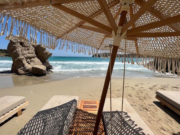 Beautiful tropical scenery two sun beds loungers under umbrella