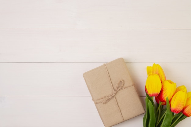 로맨틱 한 나무 배경에 아름 다운 튤립 꽃과 선물 상자, 파스텔 톤으로 어머니의 날 선물