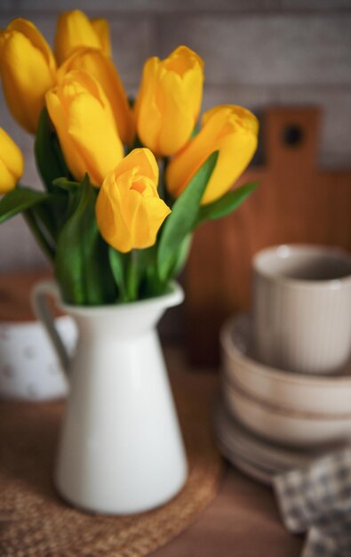 Beautiful tulip flowers on table at kitchen