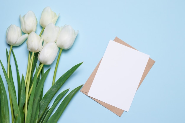 Beautiful tulips bouquet, card for text on wooden background top view.