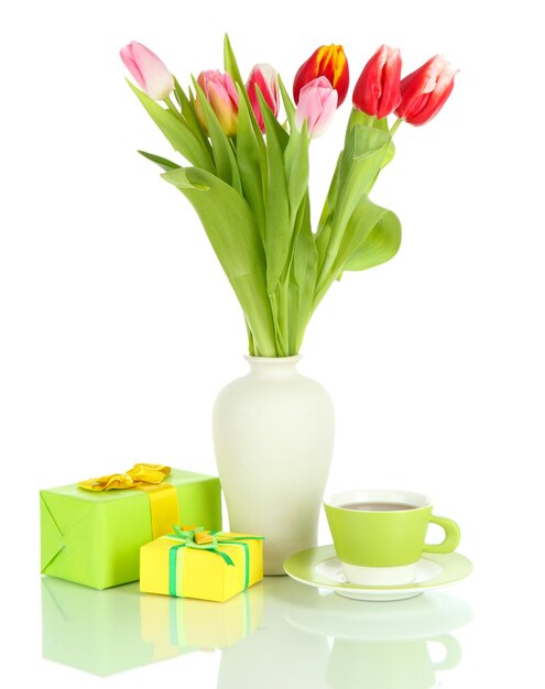 Beautiful tulips in bucket with gifts and cup of tea isolated on white