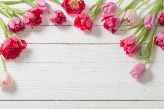 Beautiful  tulips on white wooden background