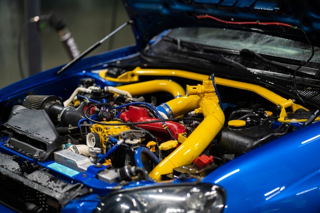 A beautiful turbo sport car engine bay with yellow pipes