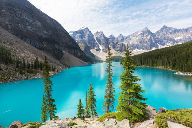 Beautiful turquoise waters of the Moraine lake with snow-covered peaks above it in Banff National Park of Canada