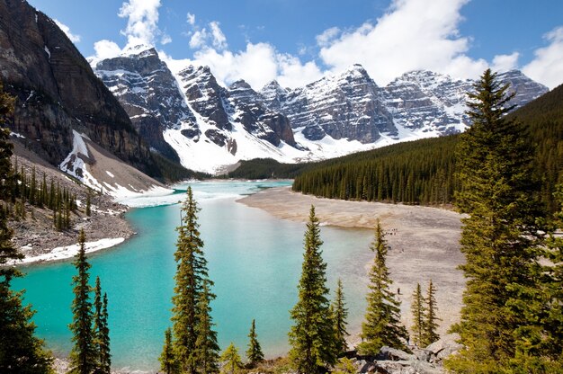 Beautiful turquoise waters of the Moraine lake with snow-covered peaks above it in Banff National Park of Canada