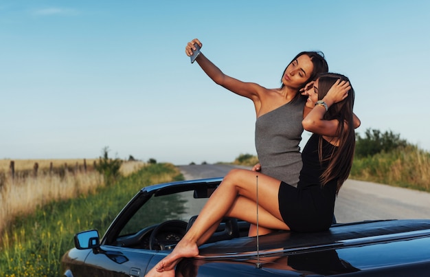 Beautiful two girls are photographed on the road