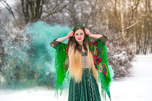 Beautiful ukrainian girl in shawl in winter park