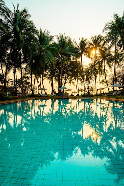 Beautiful umbrella and chair around swimming pool in hotel and resort