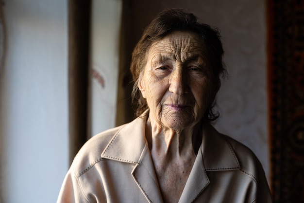 beautiful over very old woman at home near the window