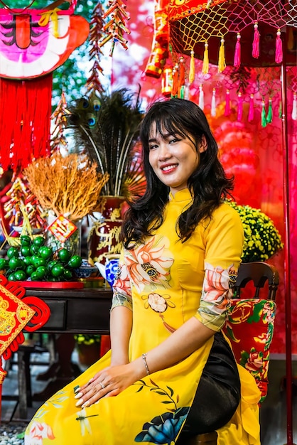 Beautiful Vietnamese woman in traditional vietnamese dress in Tet Lunar New Year