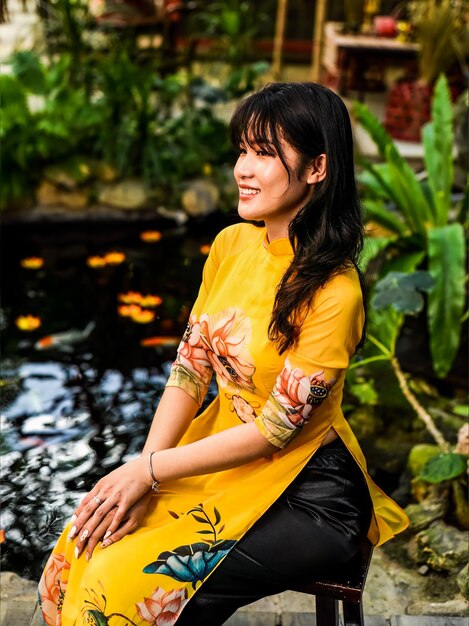 Beautiful Vietnamese woman in traditional vietnamese dress in Tet Lunar New Year