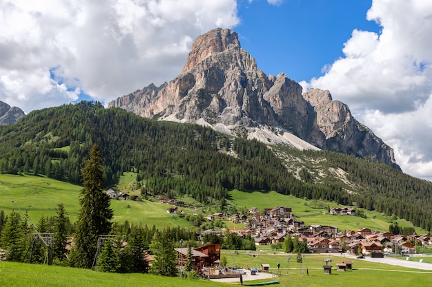 Beautiful view of the alpine village Corvara at the foot of the mountain Sassongher