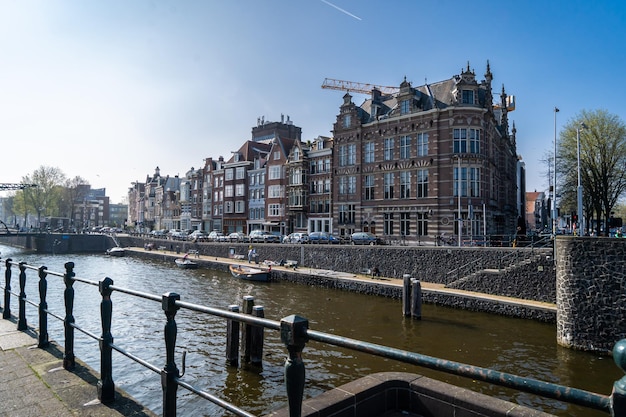 Beautiful view of Amsterdam canals with bridge and typical dutch houses Holland