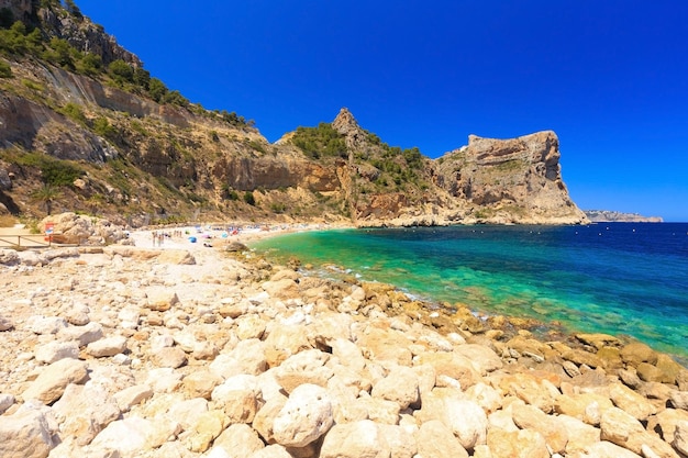 Beautiful view of beach in a bay with turquoise water la playa moraig in cumbre del sol spain