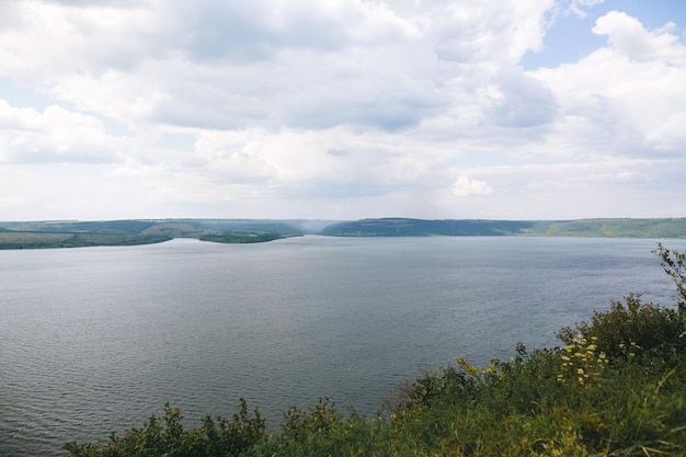 Beautiful view on big lake among hills river and cliffs\
landscape bakota lake and dnister river in ukraine travelling and\
exploring national park camping on summer vacation