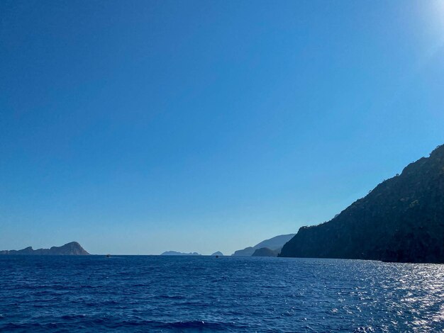 Beautiful view of the blue sea and high rocky mountains in a tourist tropical country for vacation