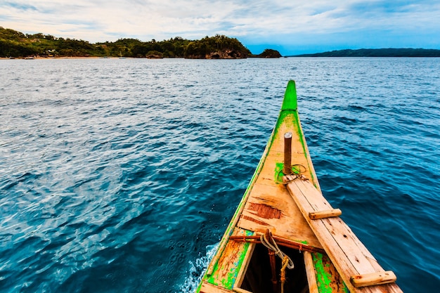 Beautiful view of calm water and ashore captured from a small wooden boat