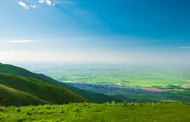 beautiful view from the green hill with a small town downhill