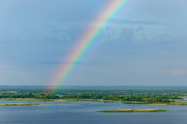 A beautiful view from the high bank of the Dnieper near the village of Vitachev of the rainbow over the river Ukraine