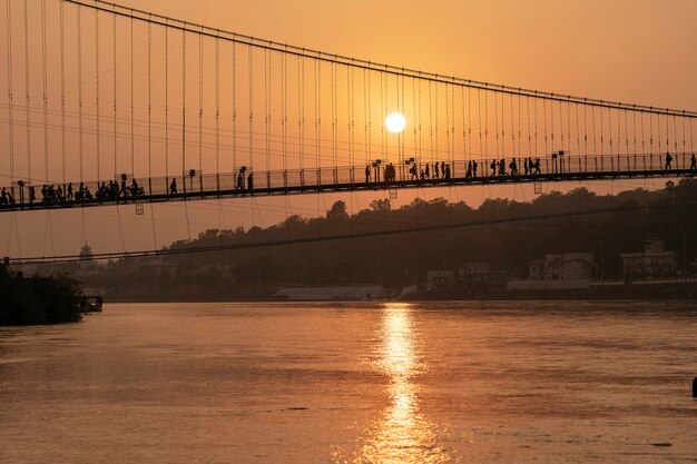 Beautiful view of Ganges river embankment and bridge at sunset Rishikesh India