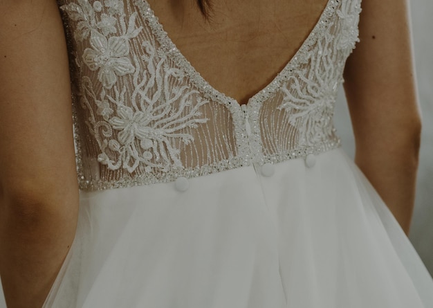 Beautiful view of the lace wedding dress on the bare back of the brideclose up side view