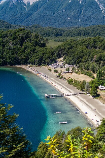 A beautiful view of lake espejo with its turquoise waters and the mountains in the background villa la angostura