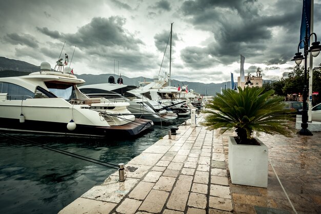 Beautiful view of moored luxurious yachts at cloudy and rainy day