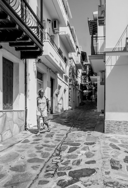 Beautiful view of old white houses in Cycladic style on the narrow streets Skopelos island in Greece