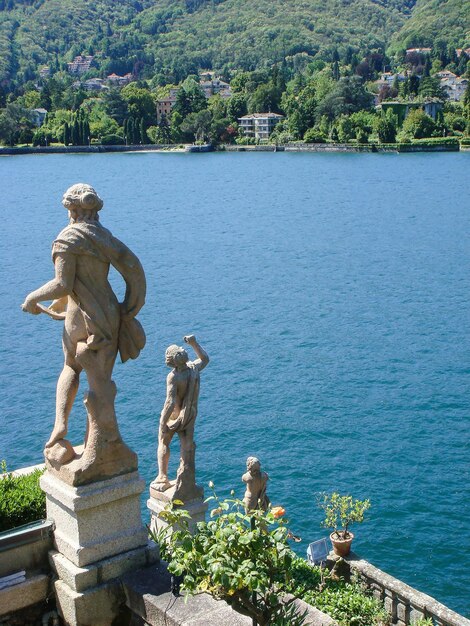 Beautiful view of the sculpture and lake on a summer day Isola Bella Italy