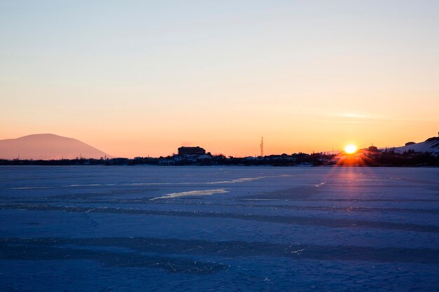 Beautiful view of snow-covered mountains and lake sevan covered with ice in armenia