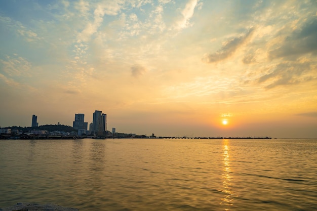 Beautiful view of the Sriracha beach and high rise buildings during sunset in Chonburi Thailand