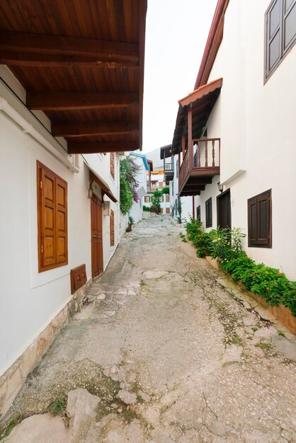 Beautiful view of street in the old city with white facades and green plants in pots