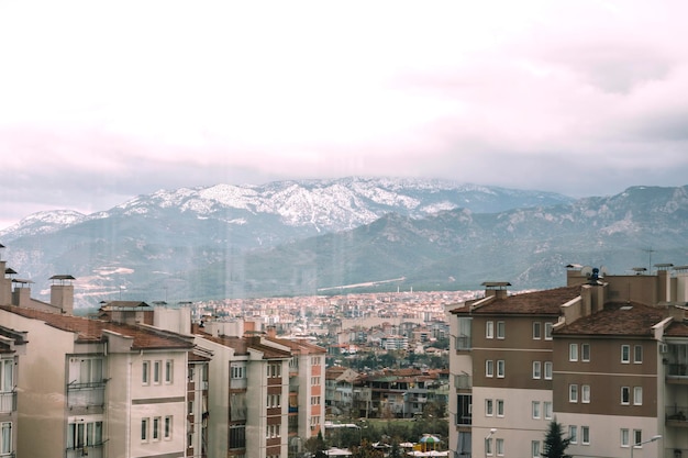 A beautiful view of tall buildings and snowy mountains