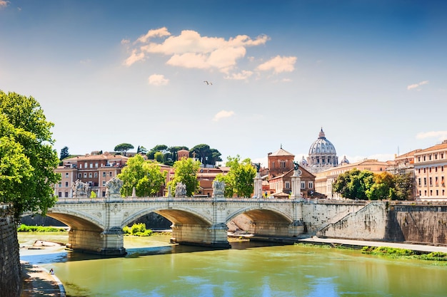 Beautiful view of the Tiber river, bridge and St. Peter's cathedral in Rome, Italy