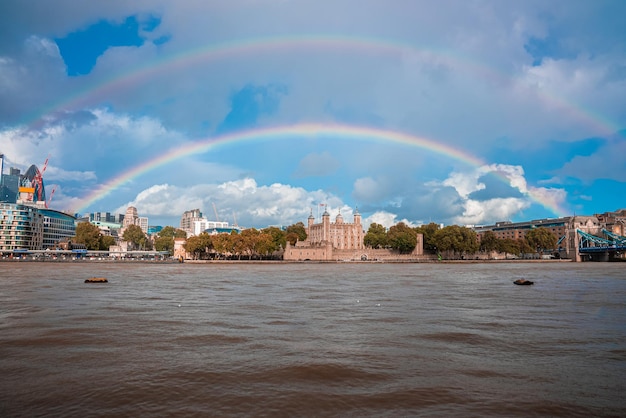 Beautiful view of the Tower bridge in London with a full rainbow over the Tower of London castle.