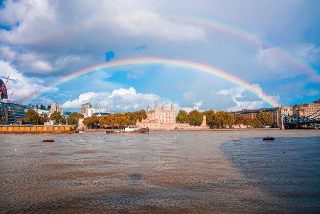 Beautiful view of the Tower bridge in London with a full rainbow over the Tower of London castle.