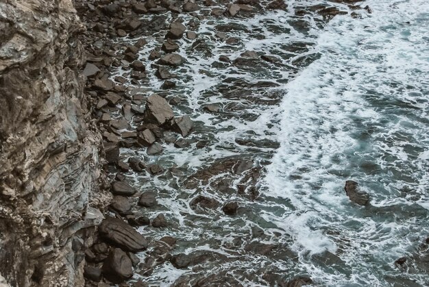 Beautiful view of the waves crashing between the multiple rocks of the Barrika cliffs in Spain