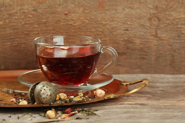 Beautiful vintage composition with herbal tea on wooden table