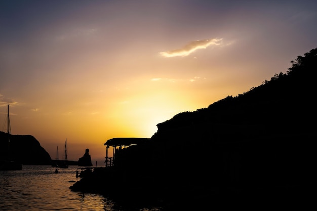 Beautiful and warm sunset in the Mediterranean Sea from the coast of Ibiza sun hiding on the horizon