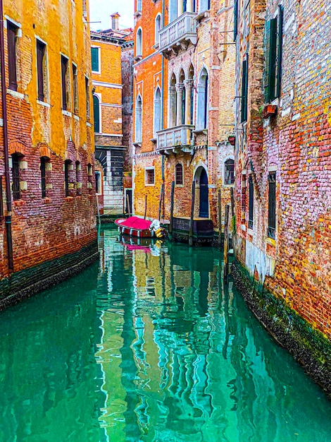 Beautiful water reflections in the small canal Venice Italy