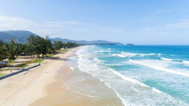 Beautiful wave crashing on sandy shore at karon beach in phuket Thailand