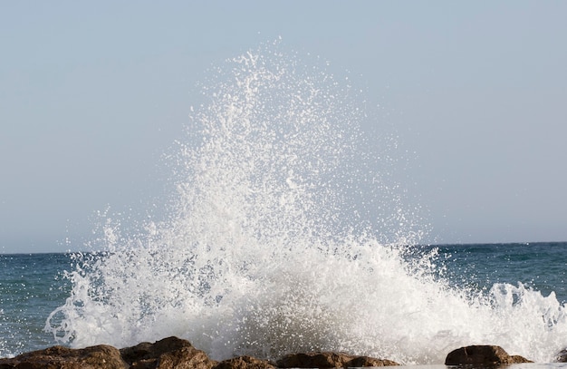 Beautiful waves crashing on the rocks of the bay