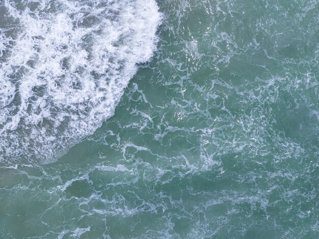 Beautiful waves sea surface in sunny day summer background Amazing seascape Top view beach sea background